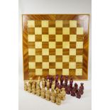 A composition chinoiserie chess set and board, complete, 24" x 24"