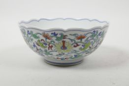 A Chinese doucai porcelain bowl with a lobed rim and all over lotus flower decoration, 6 character