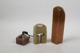 A Chinese amber soapstone seal and another smaller, together with a double seal blank, largest 6"