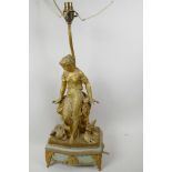 A gilt metal table lamp cast as a Grecian girl seated on a rock, with amphora and two doves at her