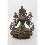 A Sino-Tibetan bronze of a female deity with distressed gilt patina, 8" high