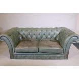 A button back leather two seat chesterfield in studded pale green leather