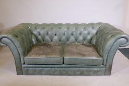 A button back leather two seat chesterfield in studded pale green leather