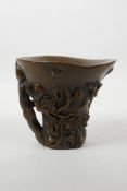 A Chinese faux horn libation cup with carved prunus blossom decoration, inscribed 4 character mark