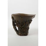 A Chinese faux horn libation cup with carved prunus blossom decoration, inscribed 4 character mark