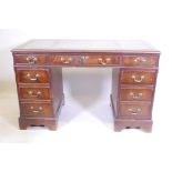 A mahogany nine drawer pedestal desk with leather inset top, 49" x 24½", 30½" high