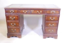 A mahogany nine drawer pedestal desk with leather inset top, 49" x 24½", 30½" high