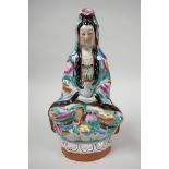 A mid C20th Chinese seated Guan Yin porcelain figure, enamelled in the famille rose palette with