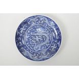 A Chinese blue and white porcelain dish decorated with dragons chasing the flaming pearl, 6