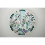 A Chinese famille verte porcelain charger decorated with a noble and his subjects, 6 character