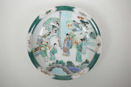 A Chinese famille verte porcelain charger decorated with a noble and his subjects, 6 character