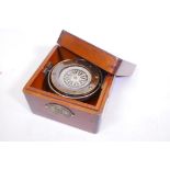A gimballed brass compass mounted in a wood case, 5" x 5" x 3"