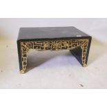 A Chinese black lacquered low table with raised parcel gilt decoration and single frieze drawers,