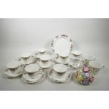 A Royal Doulton 'Autumn Fruits' set of eight teacups, seven saucers of 6" diameter and a cake plate,