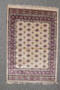 A gold ground Kashmiri rug with a Bokhara design, 46" x 66"