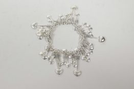 A Links of London silver bracelet adorned with heart arrows, 6" long
