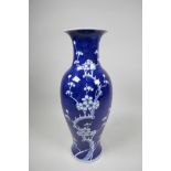 A Chinese underglaze blue and white porcelain prunus baluster vase, 5½" wide x 14" high