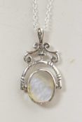 A silver revolving pendant necklace set with mother of pearl and onyx, 1" drop