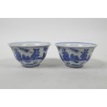 A pair of Chinese blue and white porcelain tea bowls, decorated with figures in a landscape, 6
