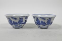 A pair of Chinese blue and white porcelain tea bowls, decorated with figures in a landscape, 6