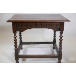 A C17th/18th oak centre table with all round carved frieze, raised on turned supports, united by