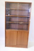 A Danish 1970s Herbert Elsibb Teak bookcase with glass doors, 36" x 11" x 68" high