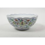 A Chinese doucai porcelain bowl with a lobed rim and all over lotus flower decoration, 6 character