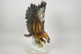 A German, Goebel style porcelain figure of a spread eagle, 15" high, 9½" wide