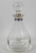 A Dartington Glass decanter of bulbous form with clear stopper having hallmarked silver collar (