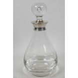 A Dartington Glass decanter of bulbous form with clear stopper having hallmarked silver collar (