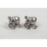 A pair of silver skull ear studs