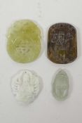 Four Chinese carved hardstone pendants decorated with deities and auspicious symbols, 2" largest