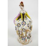A C19th Chelsea style porcelain figure of an elegant C18th lady with a lamb and floral sprays to the