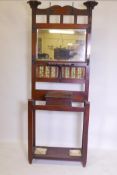 A Victorian Art Nouveau walnut hall stand, with mirrored and tiled back, some losses, 34" x 11" x