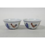 A pair of Chinese doucai porcelain tea bowls with chicken decoration, 6 character mark to base,