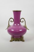 A Chinese puce glazed porcelain vase with ormolu style mounts, stand and handles, seal mark to base,