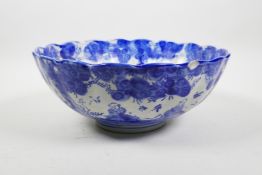 A Chinese blue and white porcelain ribbed bowl decorated with children in a landscape, 10½" diameter