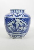 A Chinese blue and white porcelain jar with decorative panels depicting birds, insects and