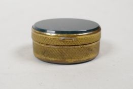 A gilt metal oval pill box with inset bloodstone cover and base, 1½" long