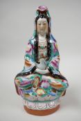 A mid C20th Chinese seated Guan Yin porcelain figure, enamelled in the famille rose palette with