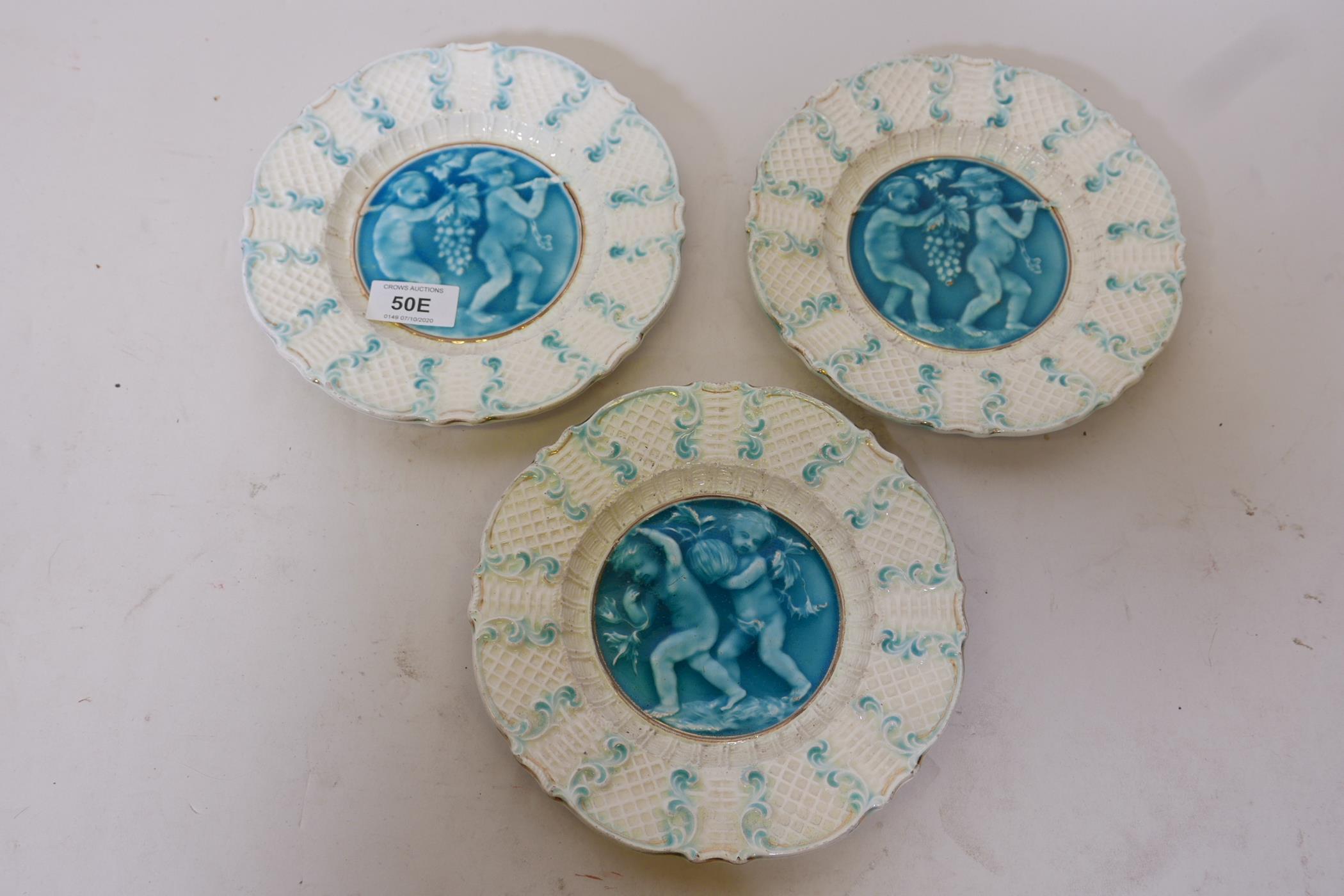 Three C19th French faience plates with putti decoration, in the style of Rupelle, impressed to