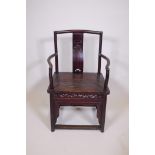 A Chinese late C19th/early C20th hardwood elbow chair with a carved splat back, 37" high