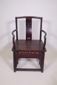 A Chinese late C19th/early C20th hardwood elbow chair with a carved splat back, 37" high