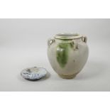 A Chinese pottery vase with four lugs and green drip glaze, together with a small early blue and