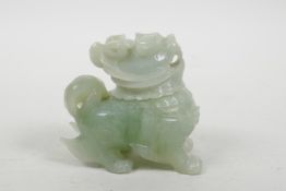 A Chinese carved green jade box and cover in the form of a kylin, 3" high