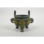 A Chinese bronze two handled censer raised on tripod dragon mask feet, the body decorated with