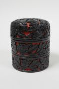 A C19th Chinese carved cinnabar red and black lacquer stacking trinket box, in three sections,