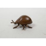 A Japanese Jizai style bronzed metal beetle, impressed mark to base, 2½" long