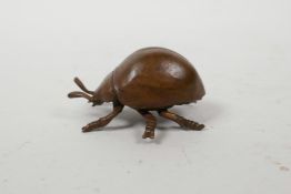 A Japanese Jizai style bronzed metal beetle, impressed mark to base, 2½" long