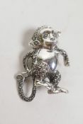 A 925 silver and marcasite brooch in the form of a monkey, 1½"